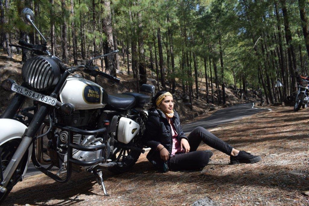 Divya with her motorcycle in the woods in 2017