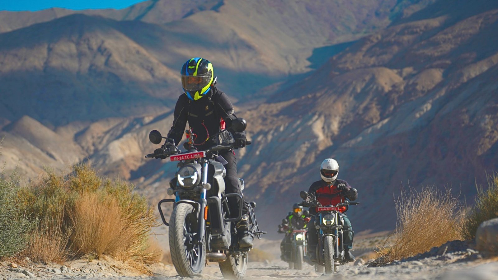 Motorcyclists crossing a mountain landscape